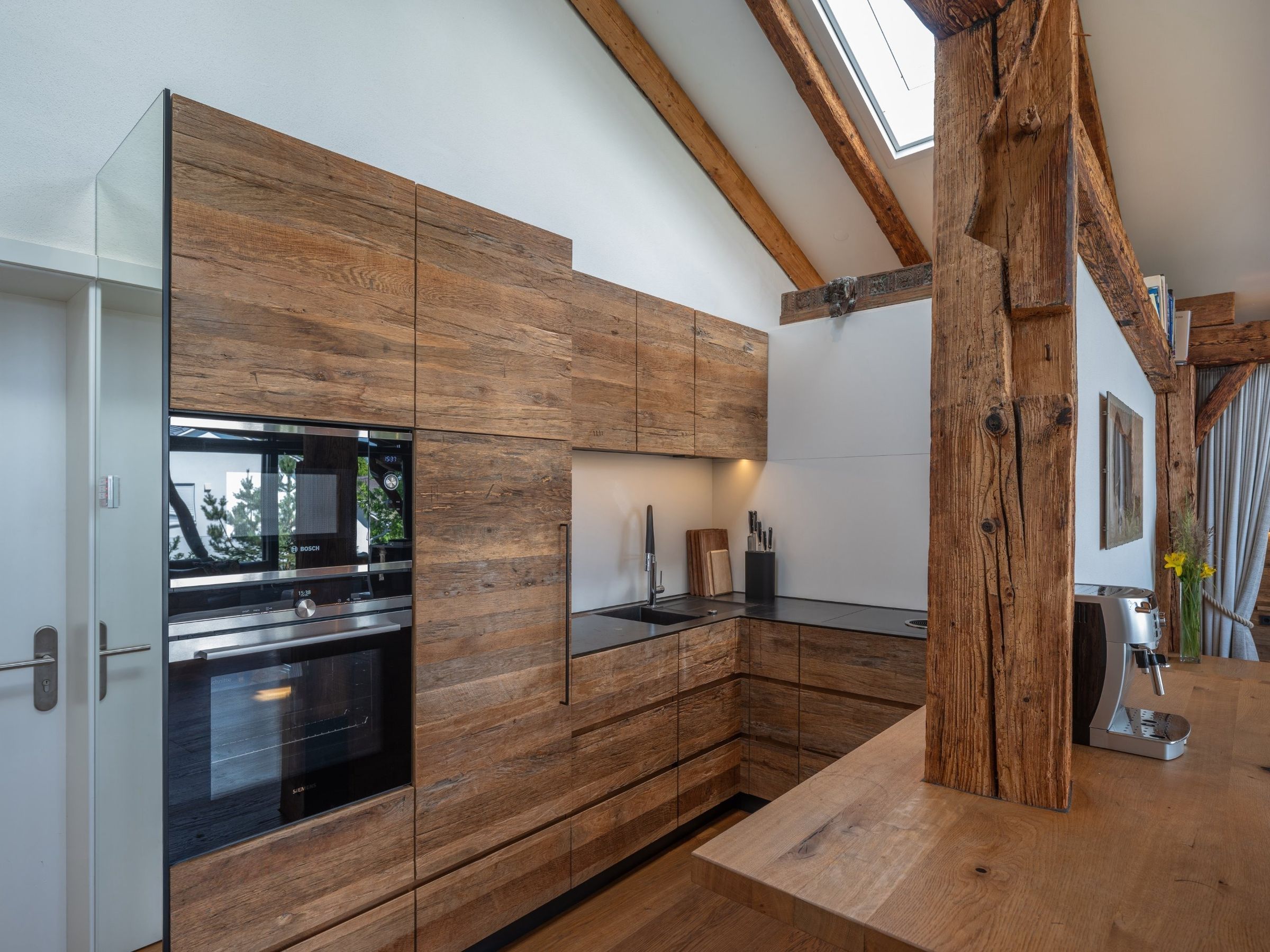 Penthouse: kitchen with reclaimed-wood fronts, oven and hob
